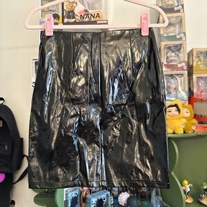 Forever 21 black vinyl or faux leather mini skirt with a front zipper closure